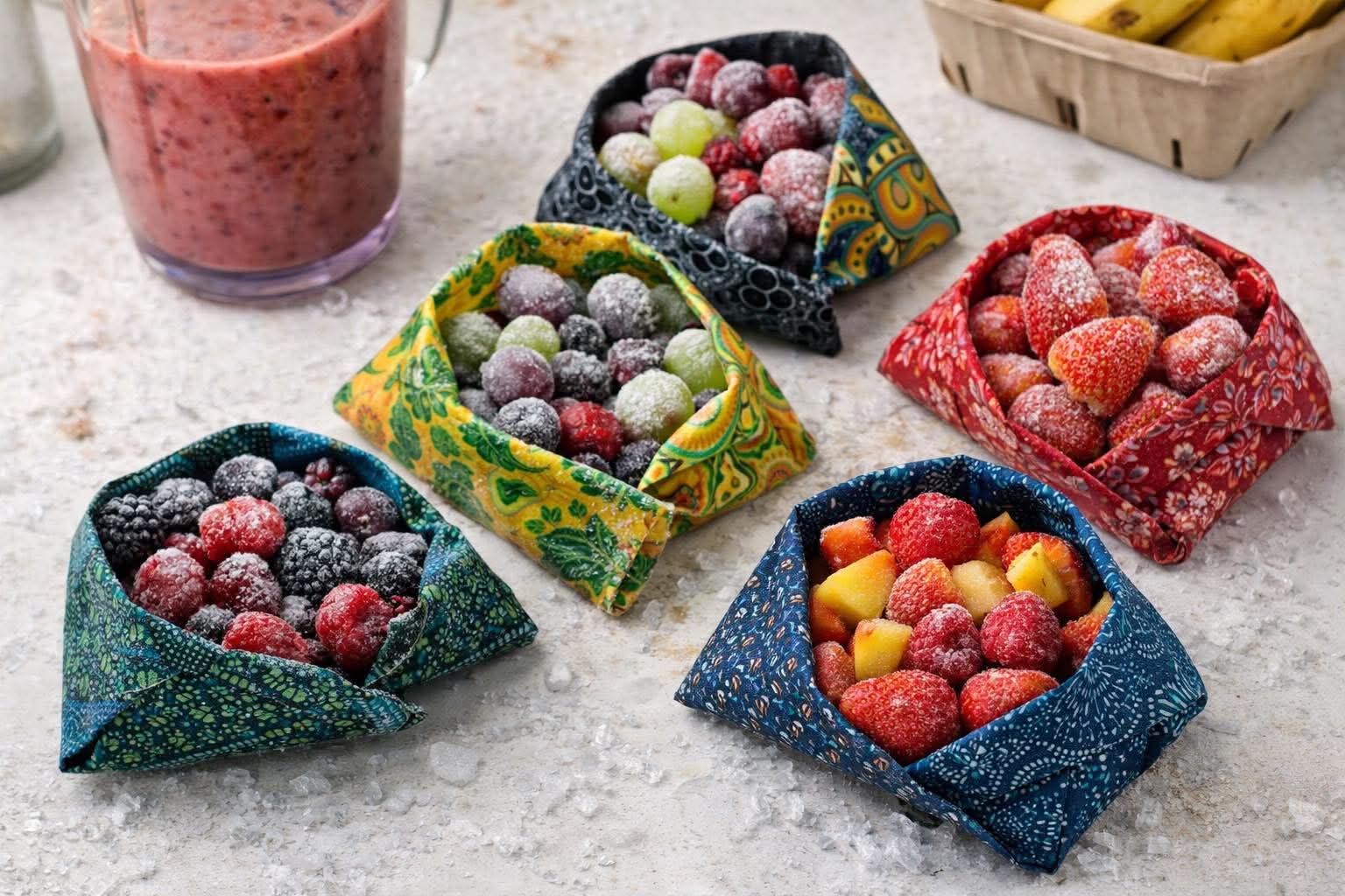 Beeswax wraps holding broccoli, cauliflower, rice cakes and trail mix on a wooden board